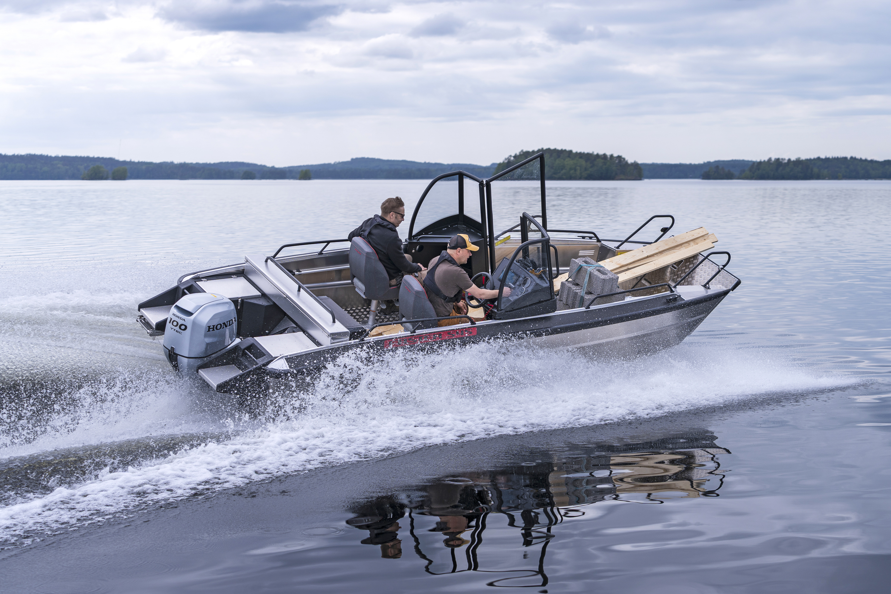 A wheelchair-bound boater sitting in his wheelchair in the open bow of the Faster 545 SCA model.